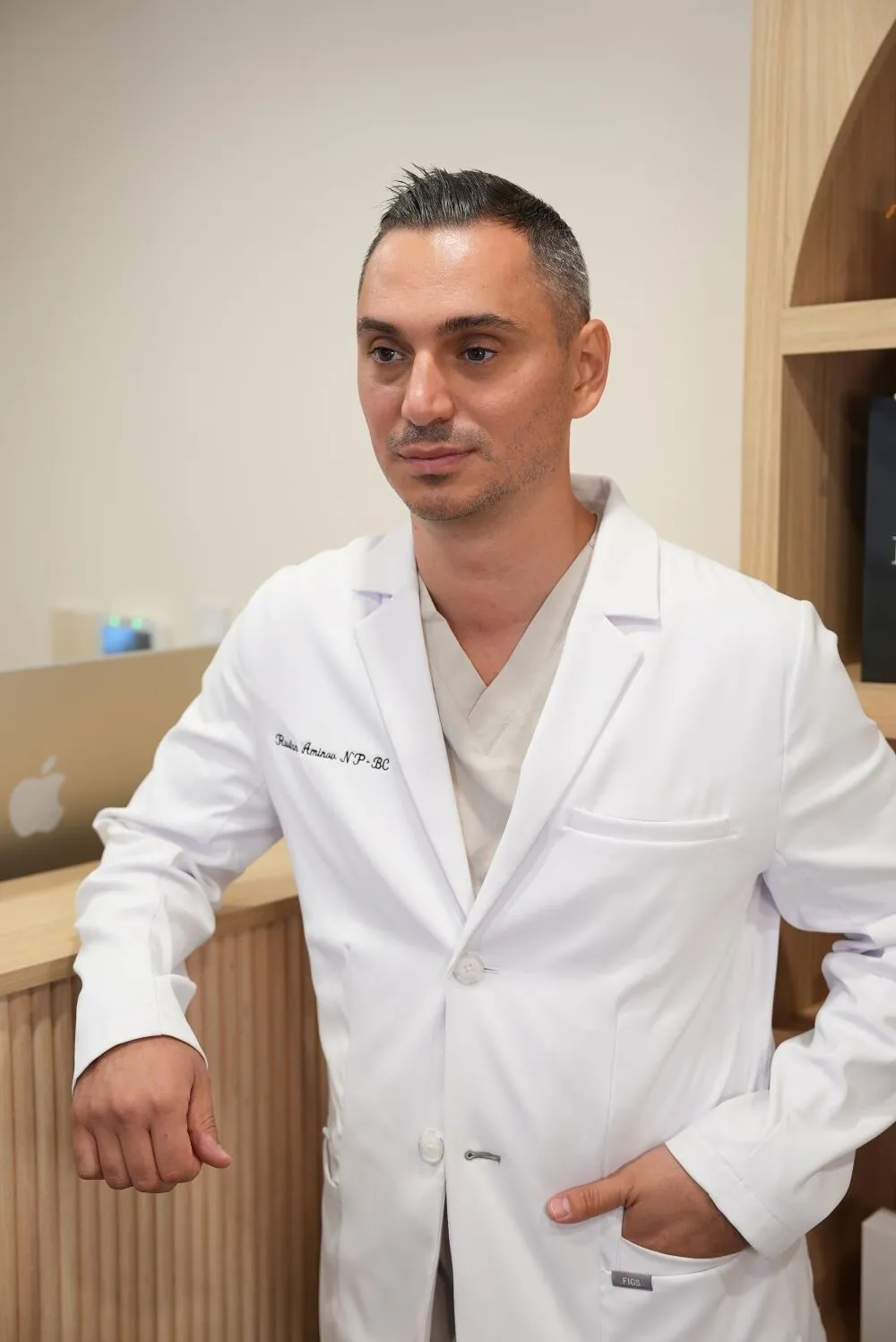 Russ Aminov, NP, founder of Future Face & Body, in his white coat at the practice