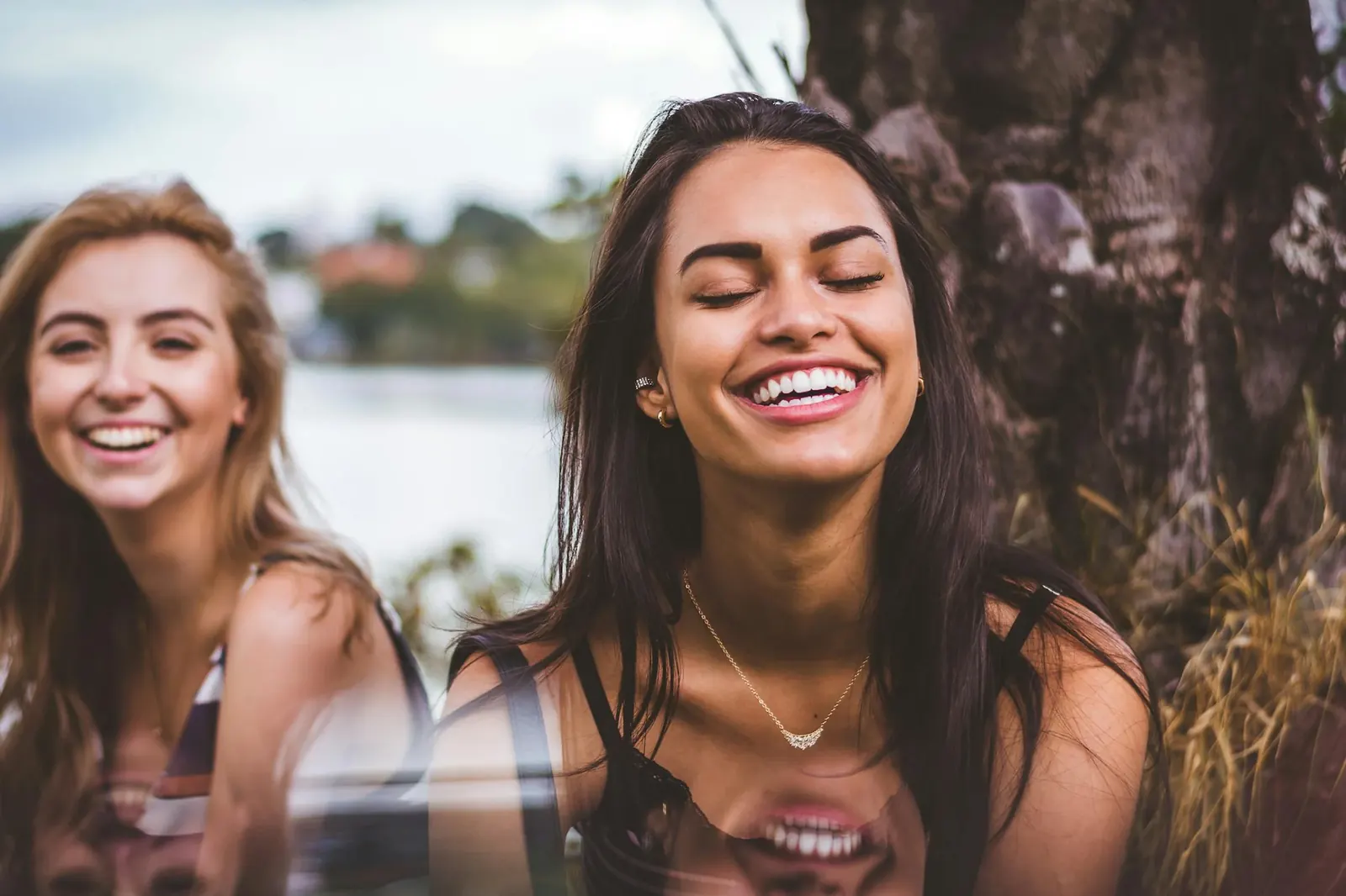 Two friends laughing together outdoors